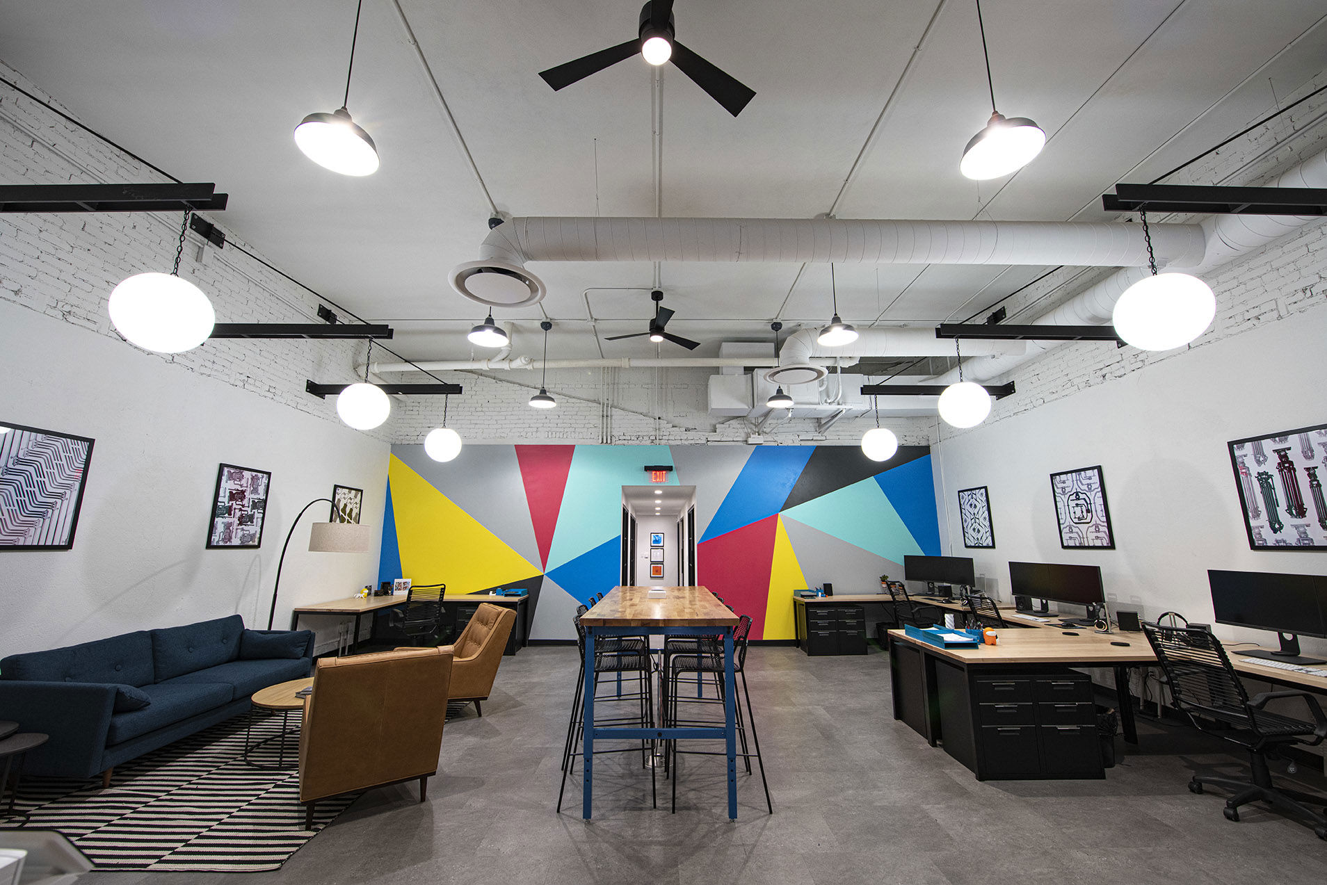 Bullpen style office area with large colorful mural