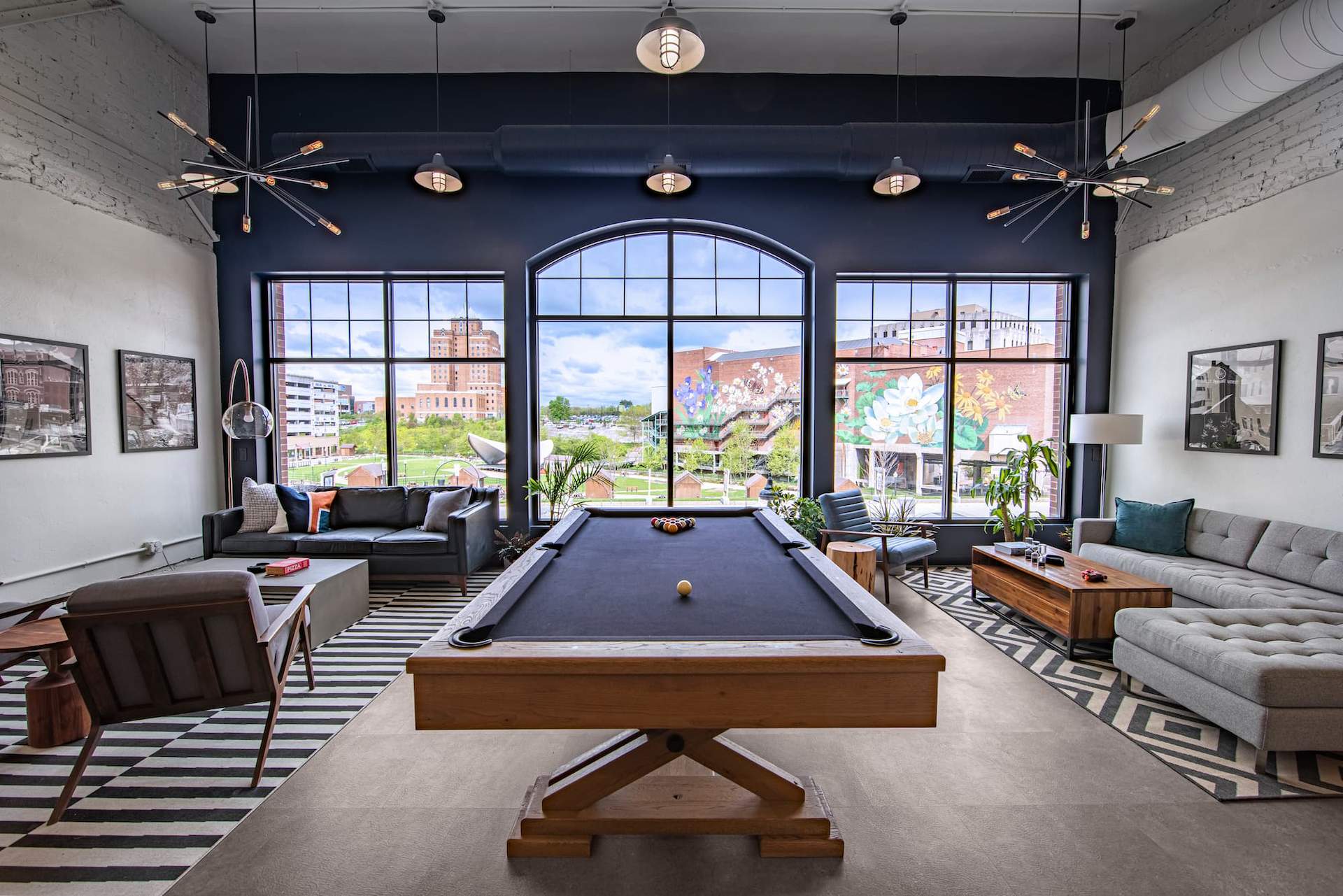 Front Lounge Area with pool table, couches and large front windows overlooking Lock 3