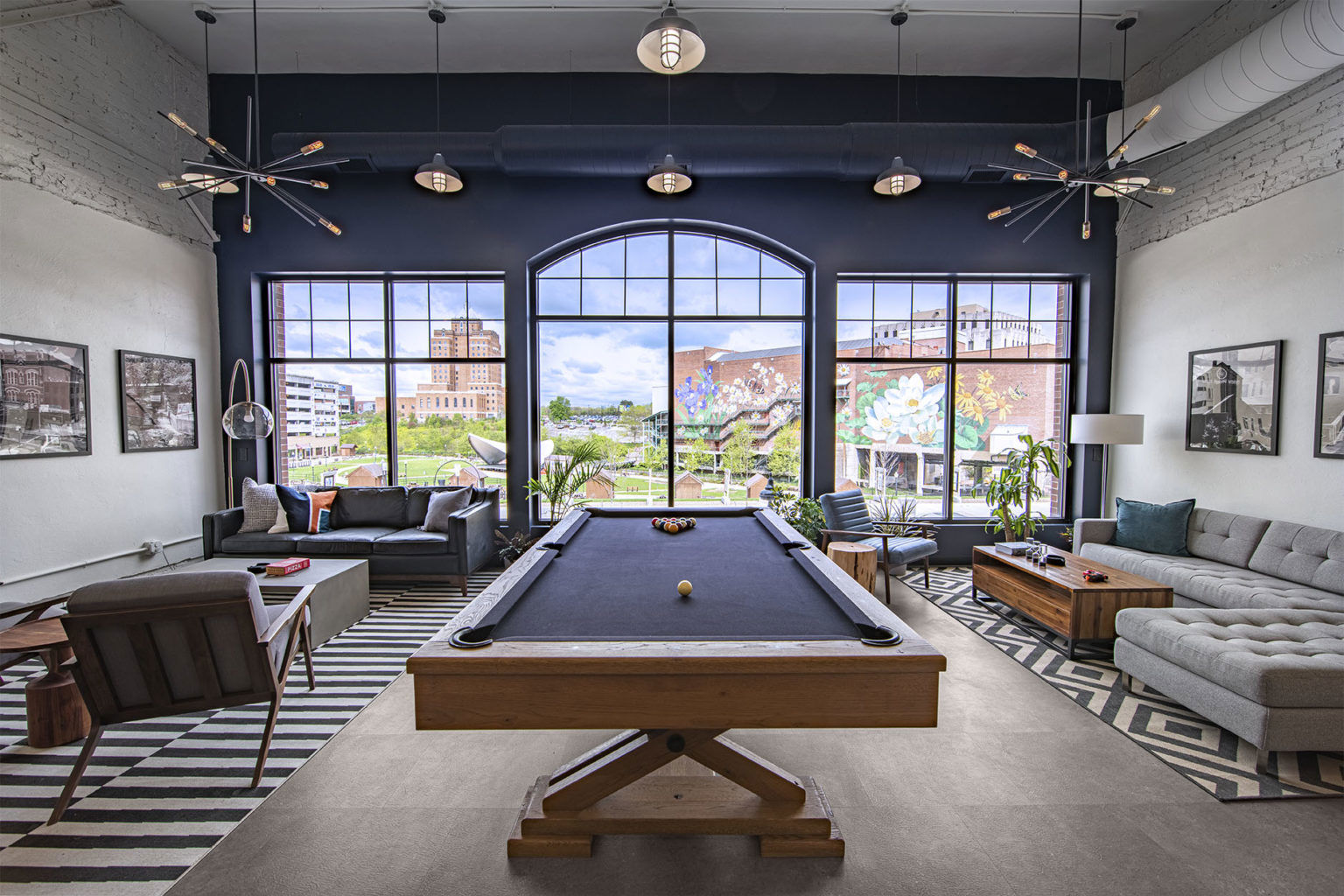 Front Lounge Area with pool table, couches and large front windows overlooking Lock 3
