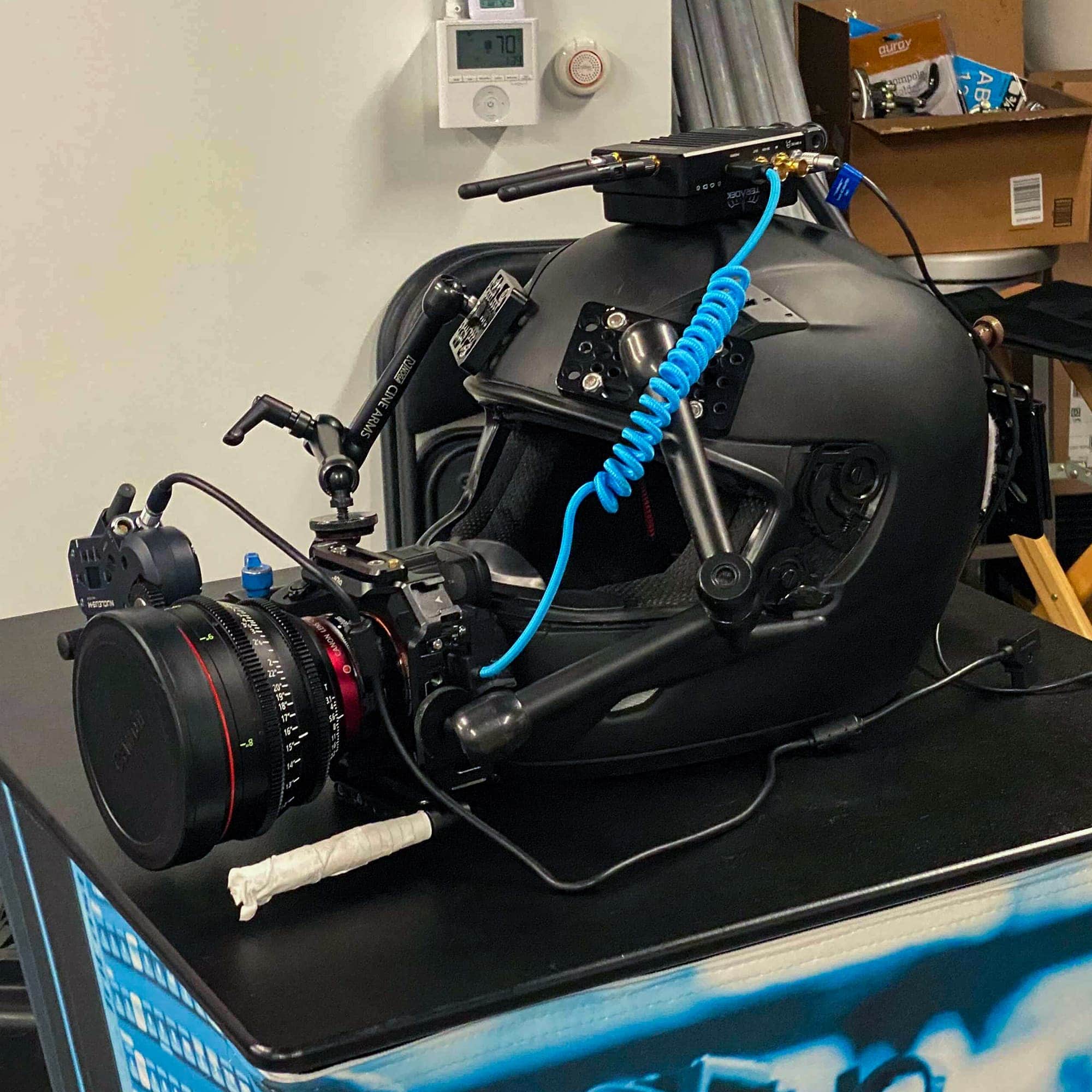 Back motorcycle helmet with Sony camera and lens attached to the front 