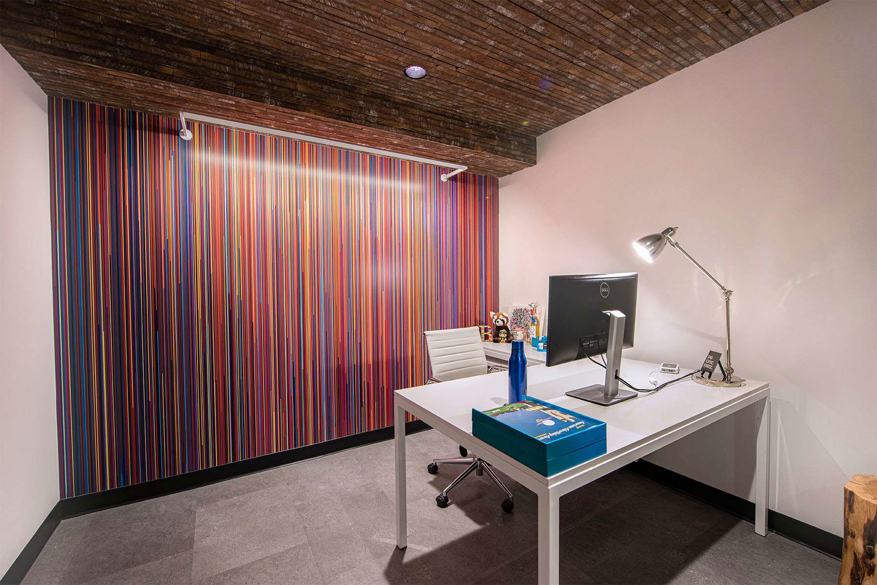 Colorful office with white desk and computer monitor