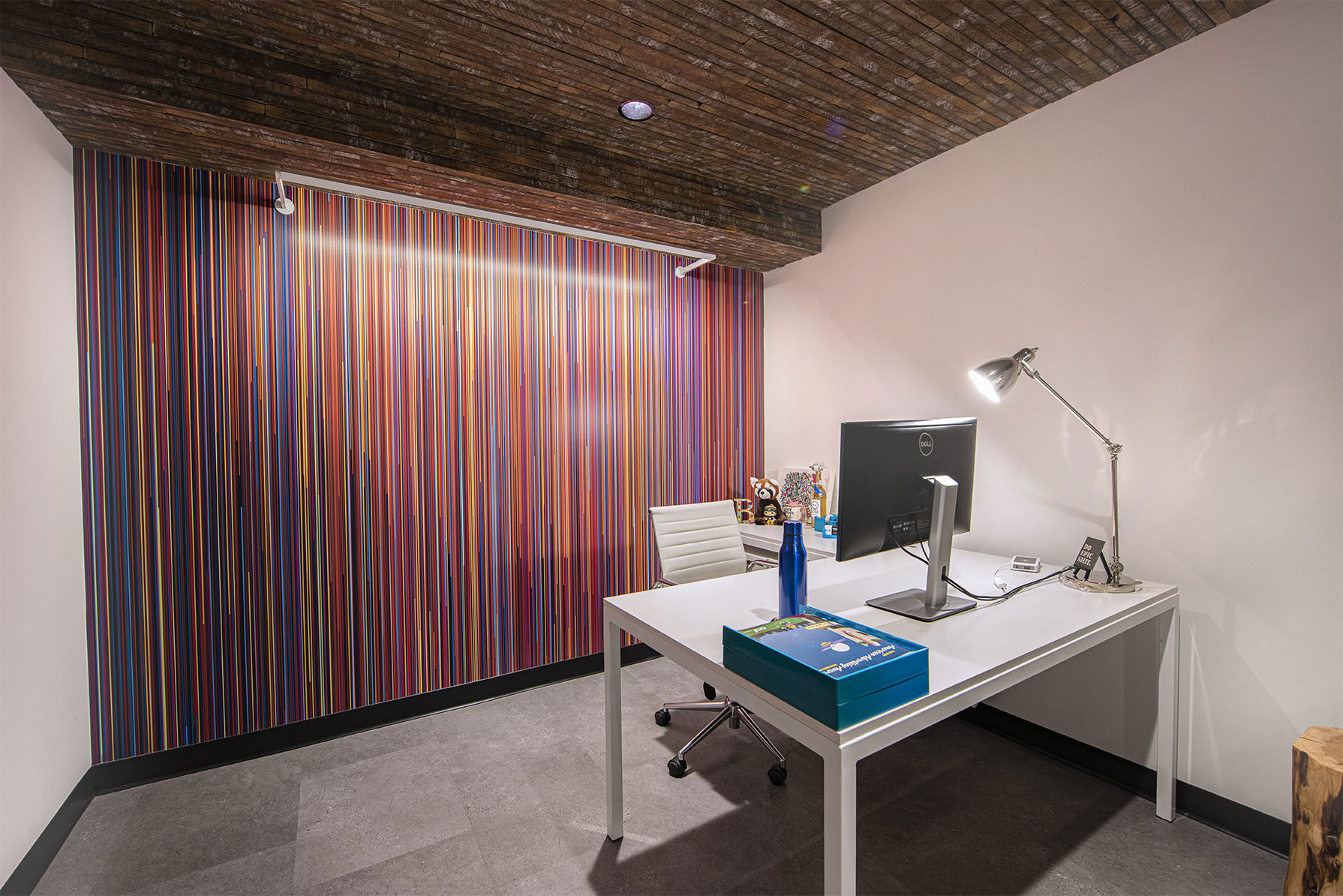 Colorful office with white desk and computer monitor