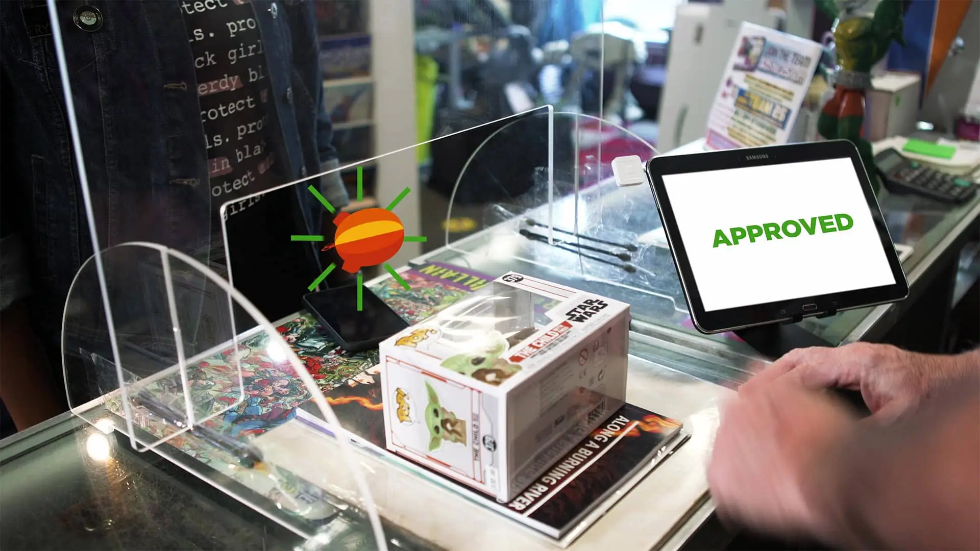 Akronite App, person is buying Funko Pop item at register, screen says APPROVED